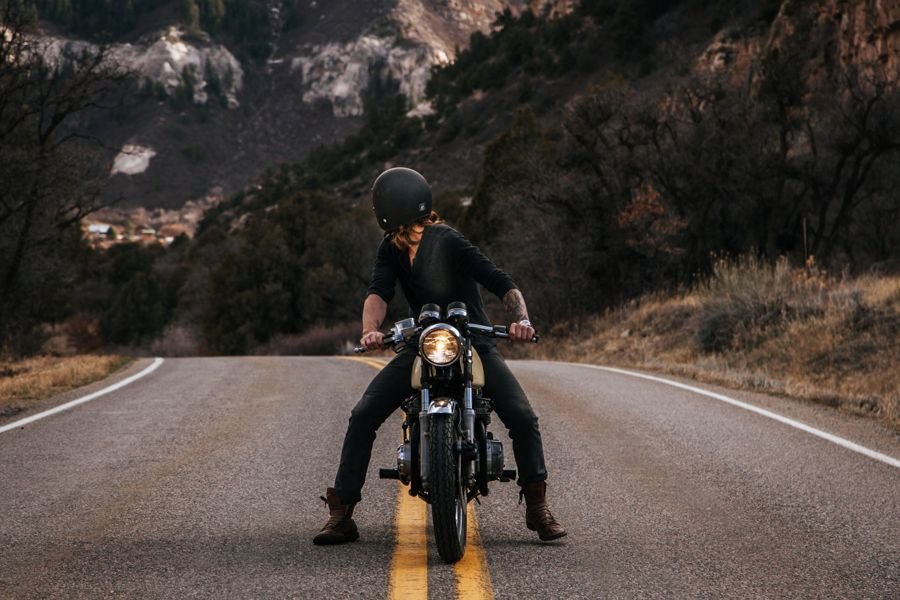 Rider on a motorcycle on a mountain road, the do-it-yourself alternative to shipping a bike from Delhi to Pune
